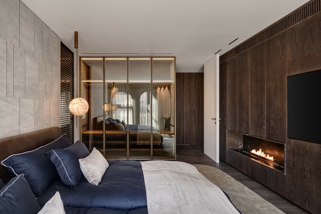 Master bedroom wardrobe with brass-framed glass doors by iKitchen Cabinetry