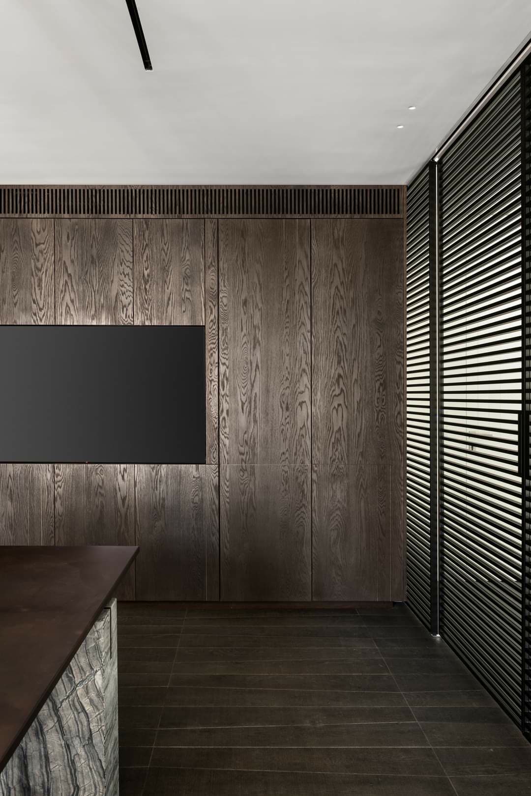 Boardroom with smoked-oak wall paneling and corporate millwork by iKitchen Cabinetry