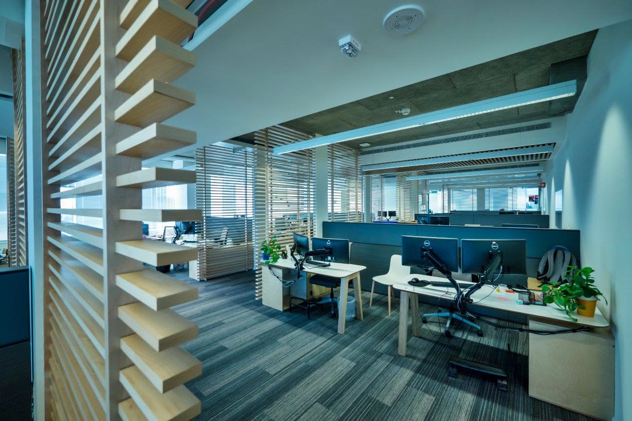 Open-plan office with custom architectural millwork by iKitchen Cabinetry