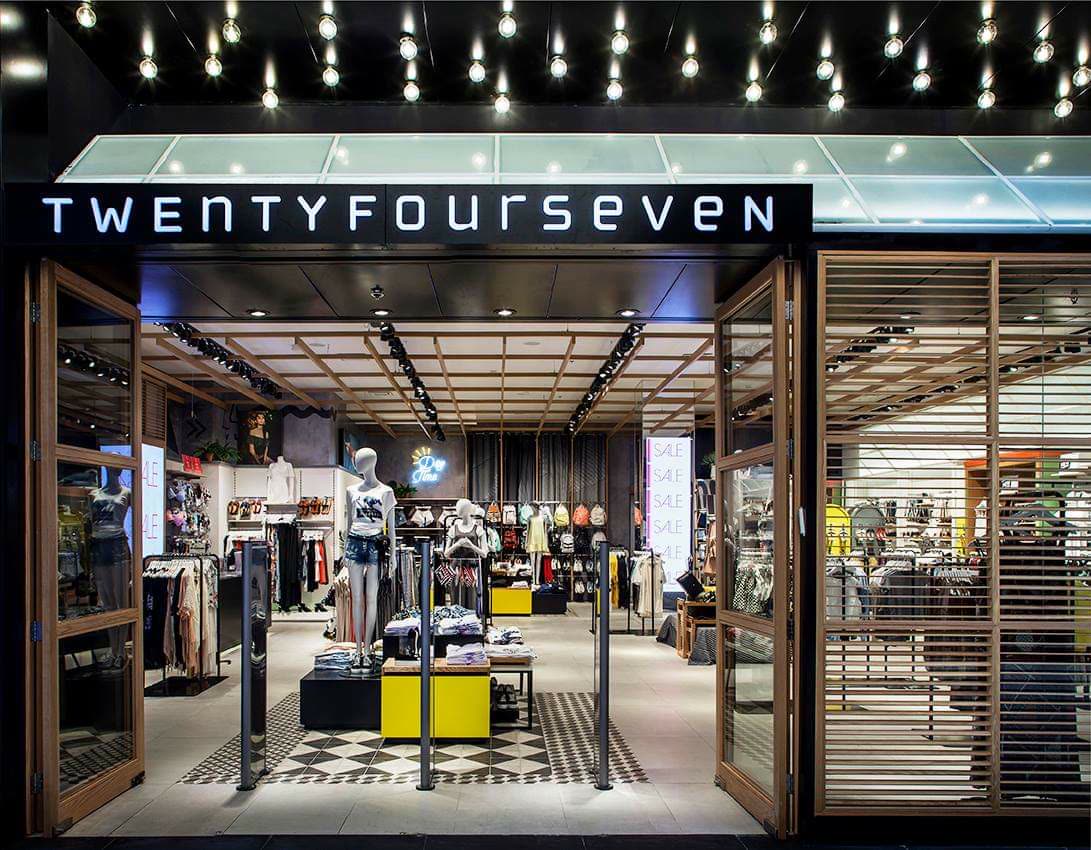 Retail display millwork with adjustable shelving and integrated lighting in a boutique interior