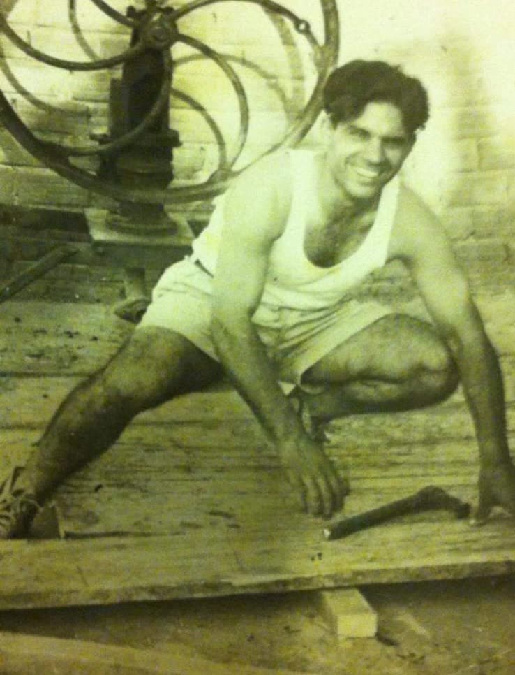 Archival photograph of a young craftsman working timber by hand