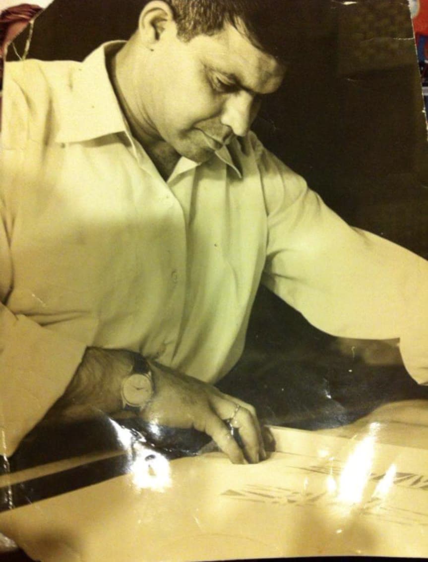 Archival photograph of a craftsman drawing cabinetry plans by hand