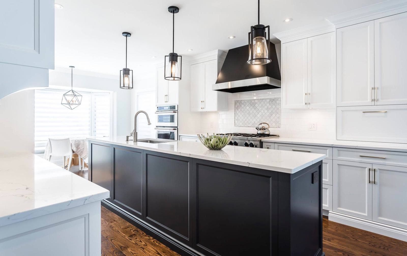 Classic white shaker kitchen with blue upholstered stools and premium millwork by iKitchen Cabinetry