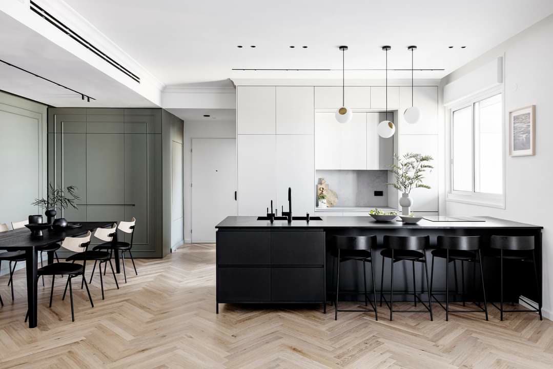 Transitional kitchen with painted paneled cabinetry and black island by iKitchen Cabinetry