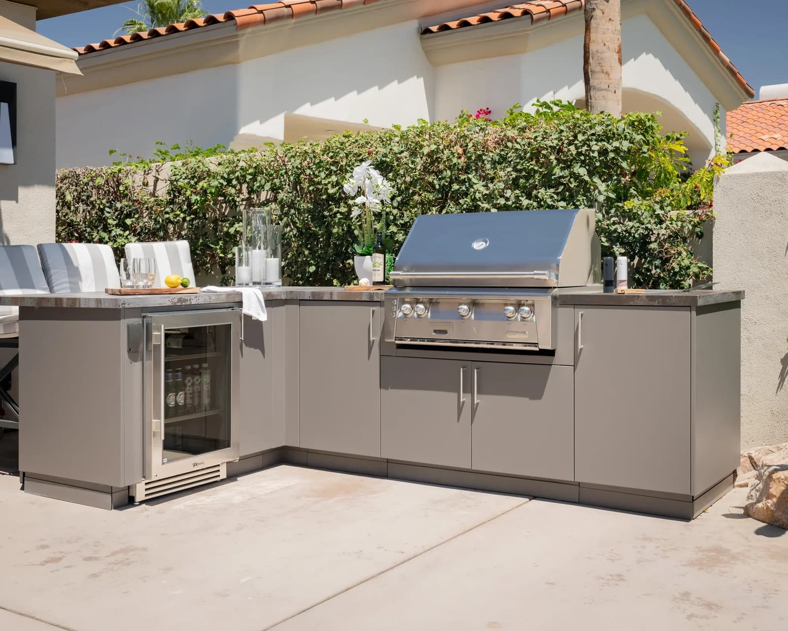 Outdoor kitchen in marine-grade aluminum with integrated grill and stone counter by iKitchen Cabinetry