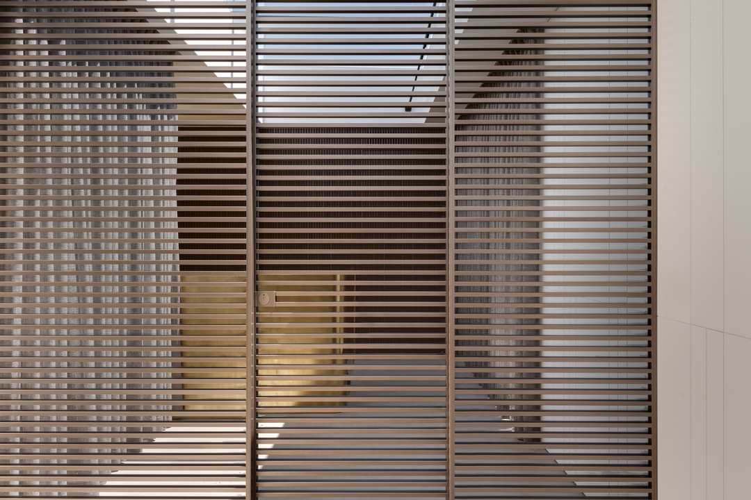 Wood louver partition and paneled passage by iKitchen Cabinetry