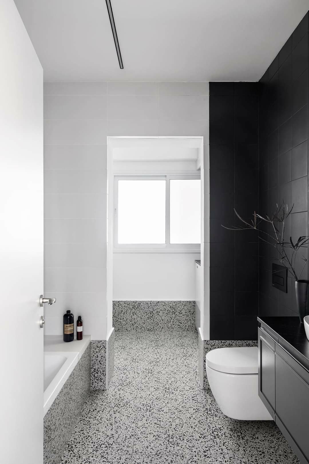 Bathroom vanity with wall sconces flanking the mirror and warm integrated lighting